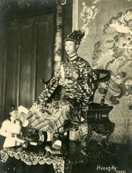 Historical photograph of Emperor Khai Dinh seated on his ornate imperial throne in Hue, Vietnam